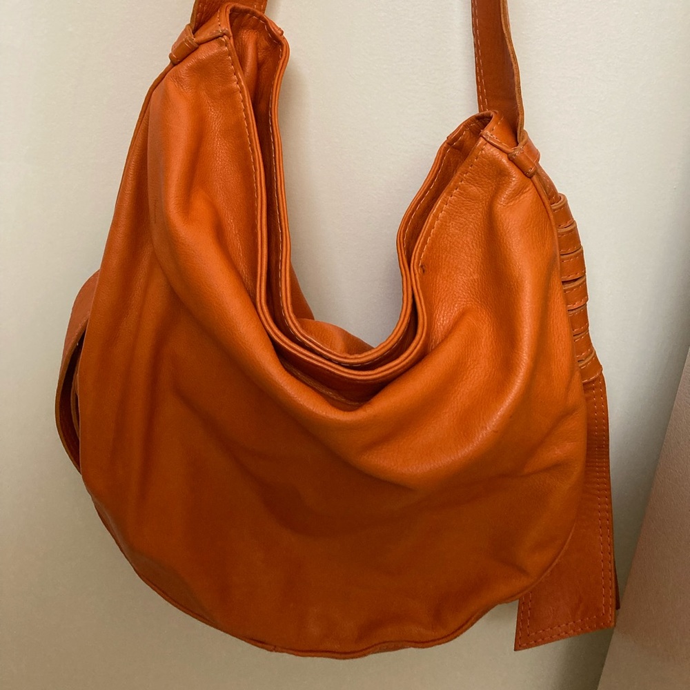 Orange leather purse. Shoulder strap.